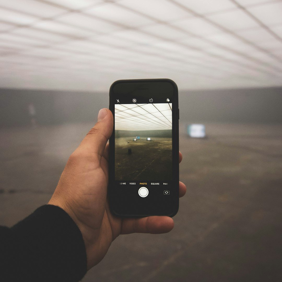 Hands holding a smartphone scrolling through trending social media posts