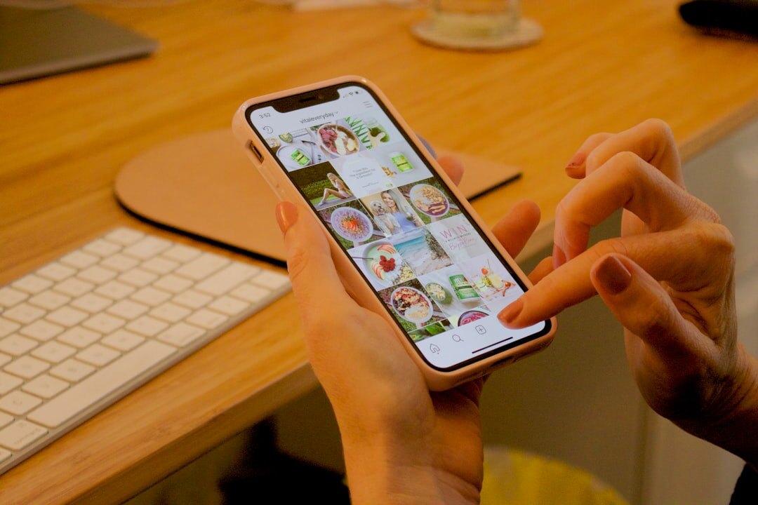 Person scrolling short video clips on a phone at a desk
