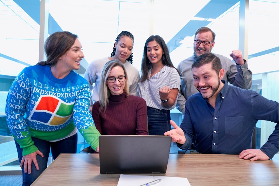 Diverse team of media trainers and journalists posing in a bright office